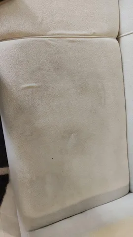 Assise de canapé en tissu clair tachée, avant le nettoyage NADIFA à Tanger